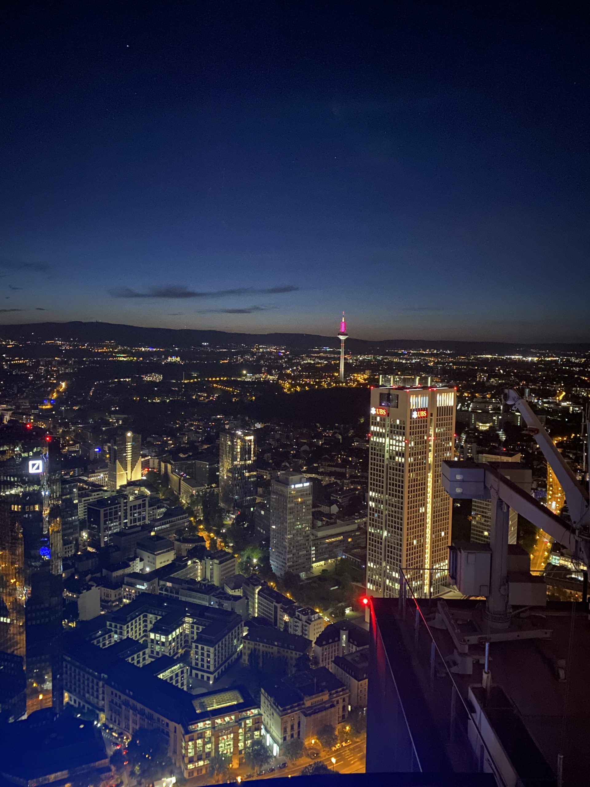 Frankfurt, Germany skyline during night time from the Maintower roof.